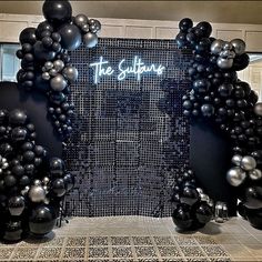 the entrance to the suppure is decorated with black and silver balloons