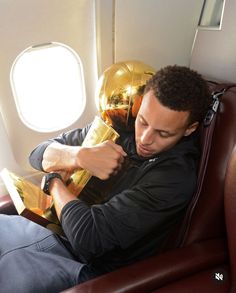 a man is sitting on an airplane and looking at something