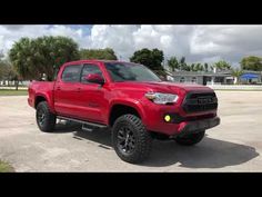 a red truck parked in a parking lot