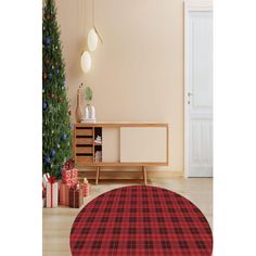 a living room with a christmas tree in the corner and a red rug on the floor