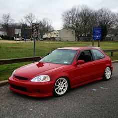 a red car is parked on the street