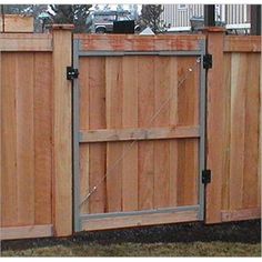 a wooden fence with metal bars on it