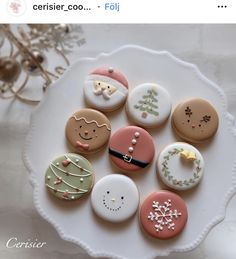 a white plate topped with lots of decorated cookies