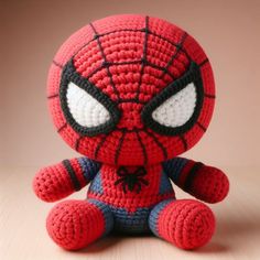 a crocheted spider man sitting on top of a table