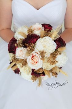 a bridal holding a bouquet of white and red flowers