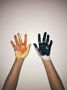 two hands are painted with different colors and designs