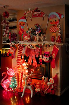 christmas decorations are displayed on the mantle in this living room, including stockings and candy canes