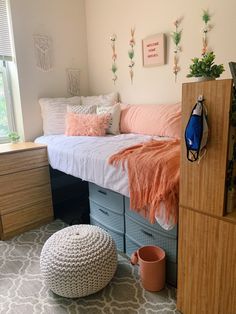 a bedroom with a bed, dresser and storage bins