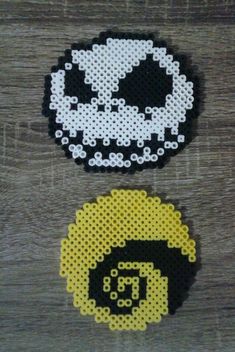 two pieces of perler bead art on wood