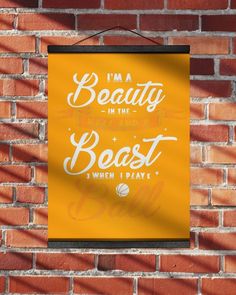 a sign hanging on the side of a brick wall that says, i'm a beauty in the beast