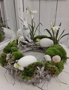 an easter wreath with moss and white eggs