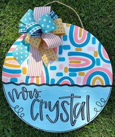 a wooden sign that says, miss crystal on it in front of some green grass