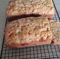 two loaves of bread sitting on top of a cooling rack