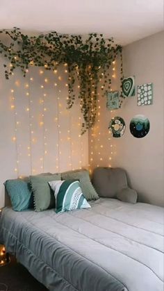 a bed sitting under a tree covered in lights