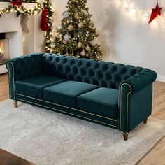 a living room with a christmas tree in the corner and a blue velvet couch sitting on top of a white rug