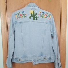 100% Cotton Classic Denim Jacket Embroidery On The Back Flowers, Cactus, And Sunshine. 21 Inches Underarm To Underarm 22 Inches Shoulder To Hem New With Tags No Flaws To Note No Trades Or Modeling Fair Offers Welcomed Or Countered Medium Wash Denim Jacket With Floral Embroidery For Summer, Casual Denim Jacket With Floral Embroidery For Summer, Summer Outerwear With Floral Embroidery In Medium Wash, Casual Floral Embroidered Denim Jacket For Summer, Casual Summer Denim Jacket With Floral Embroidery, Summer Casual Denim Jacket With Floral Embroidery, Medium Wash Floral Embroidered Denim Jacket For Summer, Summer Medium Wash Denim Jacket With Floral Embroidery, Summer Floral Embroidery Medium Wash Outerwear