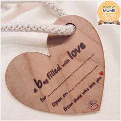 a wooden heart shaped ornament with the words be filled with love on it