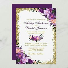 purple and gold wedding card with flowers on the bottom, in front of a marble background