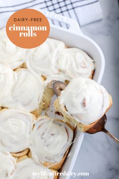 a pan filled with cinnamon rolls covered in icing