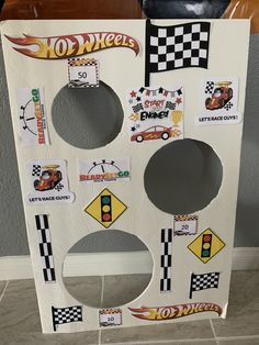 a cardboard board with cars and stickers on it