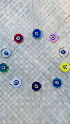 an overhead view of colorful glass objects on the ground