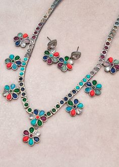 The Multi Stone Flower Necklace Set is made of German silver and features beautiful kemp stones. Length of the necklace: 13", can be adjusted with a doori Earring Length: Approx. 1.25" Weight of each earrings: 6 gms Brass as the base metal Availability: In-Stock *Color may vary slightly due to light condition & photography. Necklace Set Indian, Necklace Indian, German Silver, American Diamond, Ethnic Jewelry, Multi Stone, Flower Necklace, Wedding Necklace, Base Metal