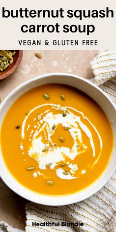 a bowl of butternut squash carrot soup with cream and pumpkin seeds on the side