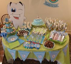 a table topped with lots of desserts and candy bar items in front of a cartoon character