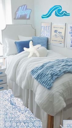 a bedroom with blue and white decor on the walls