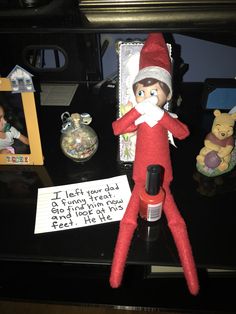 an elf is sitting on top of a desk next to a note that says i left you dad