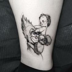 a small tattoo on the leg of a person with an animal and man hugging each other