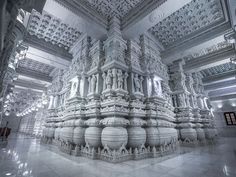 an intricately designed room with white walls and ceiling, in the middle of a building