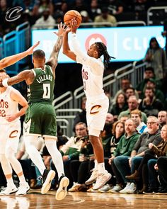 the basketball players are trying to block the ball