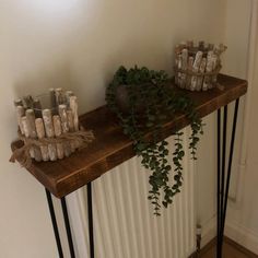 some plants are sitting on top of a shelf next to candles and jars in glass bottles