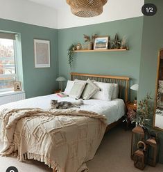 a bedroom with green walls and white bedding