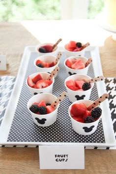 fruit cups with strawberries and blackberries in them