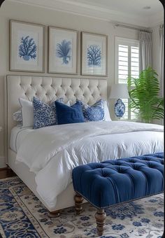 a bedroom with blue and white decor on the walls