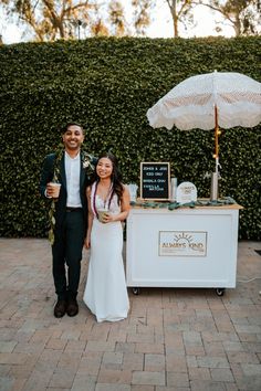 a man and woman standing next to each other in front of an ice cream stand