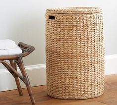 a wicker laundry basket next to a chair