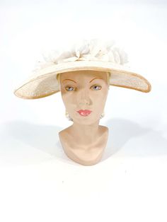 For Sale on 1stDibs - 1950s cream-colored starched lace picture hat with handmade french silk flowers, velvet trim, and bow accent. This hat is meant to be worn with a hat pin Adjustable Cream Hat For Evening, Vintage Beige Top Hat With Short Brim, Vintage Beige Top Hat With Curved Brim, Vintage Cream Fascinator For Royal Ascot, Cream Vintage Fascinator For Royal Ascot, Vintage Beige Fascinator With Curved Brim, White Vintage Fascinator For Royal Ascot, Vintage Wedding Hats With Handmade Flowers, Cream Brimmed Mini Hats For Formal Occasions