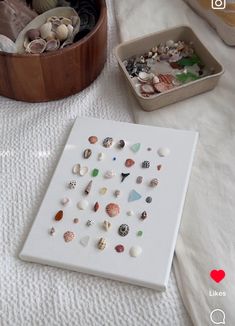 there are many seashells on the table and one is in a wooden box