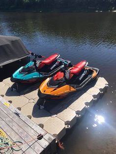 two jet skis are parked on the dock