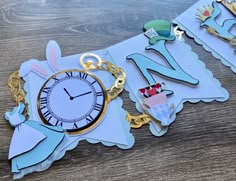 a close up of a clock on a table with paper cut outs and chains around it