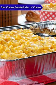 two pans filled with macaroni and cheese sitting on top of a table