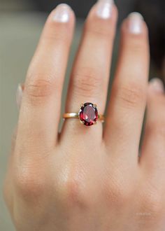 Our Garnet Gemstone Ring features a deep red faceted oval garnet set in a classic four prong setting. This January birthstone ring is Handmade in 925 silver base with a thick coating of nickel free 18k Gold Vermeil. D E T A I L S Stone size - Large - 10mm x 8mm Band size - 2mm Material: 18k thick gold vermeil over 925 sterling silver, genuine red Garnet gemstone Birthstone Month: January S H I P P I N G * Processing time - 2 business days, usually ships the next day. We are closed on Saturdays a Silver Rings With Red Stone, Gold Ring With Ruby Stone, Ruby Gemstone Ring, Gold And Garnet Ring, Oval Garnet Ring, January Birth Stone Rings, Gold Stone Rings For Women, Garnet Silver Ring, Ruby Oval Ring