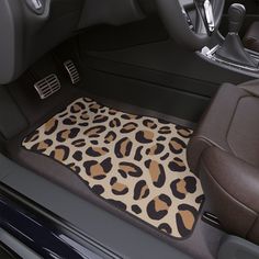 the interior of a car with a leopard print floor mat