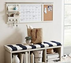 a white and black striped bench with a calendar on the wall