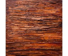 an abstract painting with red and brown colors on the wood grained surface is shown