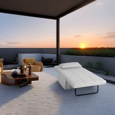 an outdoor living room with couches and tables on the patio at sunset or dawn