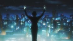 a person standing in front of a cityscape at night with their hands up